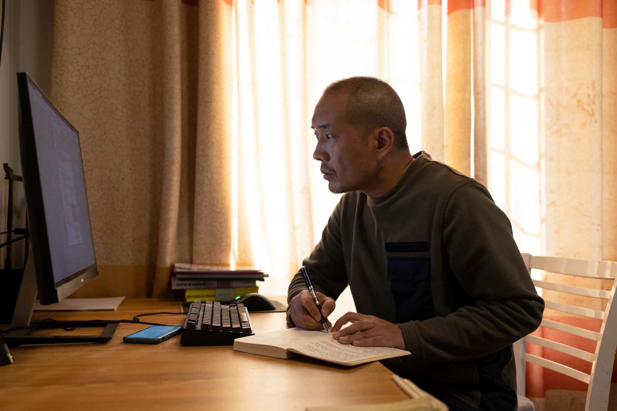 Author working at a desk from home with books nearby