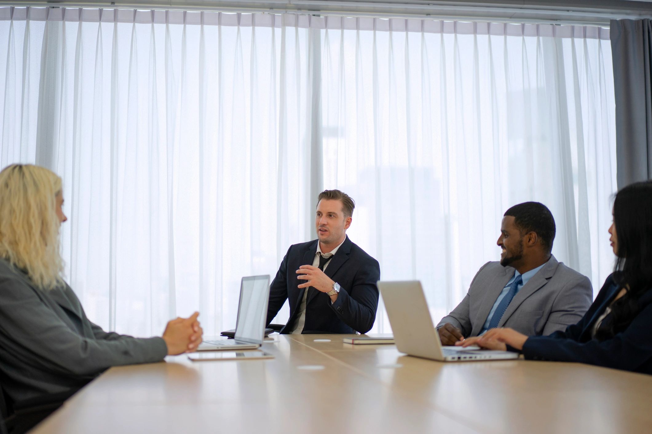Professionals meeting around a table with books and documents